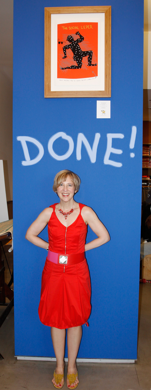 Franke James at book reading for Bothered by My Green Conscience, holding large copy of book for presentation; photo by Central Image Agency