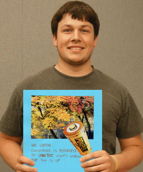 University of Cincinnati student holds up his Green Conscience art work