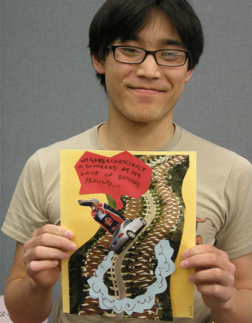 University of Cincinnati student holds up his Green Conscience art work